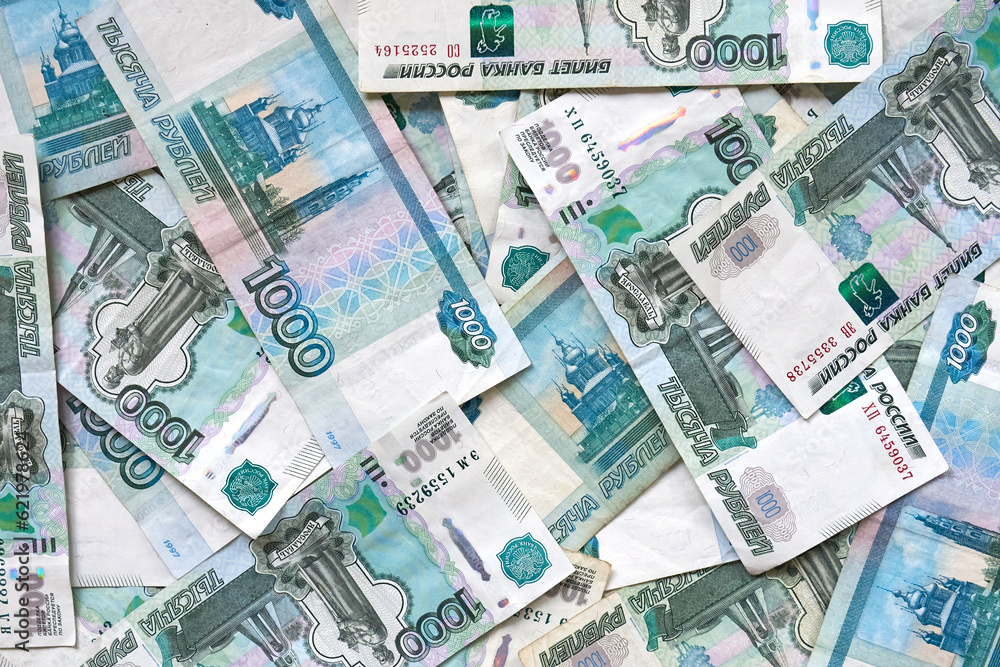 Fototapeta premium A background of banknotes of 1000 rubles. Currency exchange rate