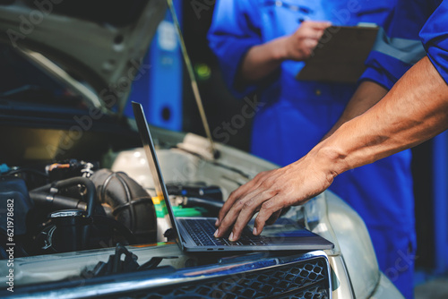 Mechanic inspects and maintains the engine for the customer. An app to write checklists for repair machines, car services and maintenance to the clipboard. © Daenin