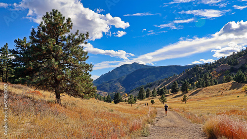 Hiker on Boulder, Colorado's Sanitas Valley Trail in the fall photo
