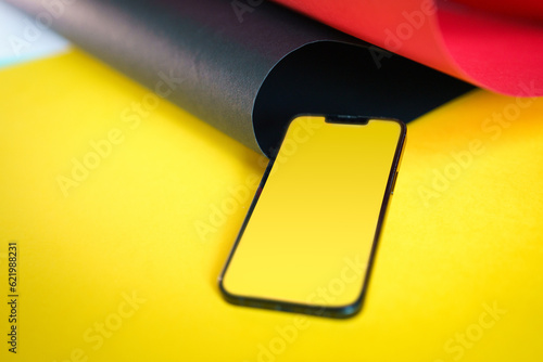 Smartphone blank screen mockup. Colorful yellow background photo