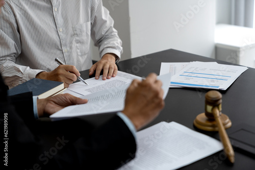 Lawyer pointing to document and discussing legal text in lawsuit photo