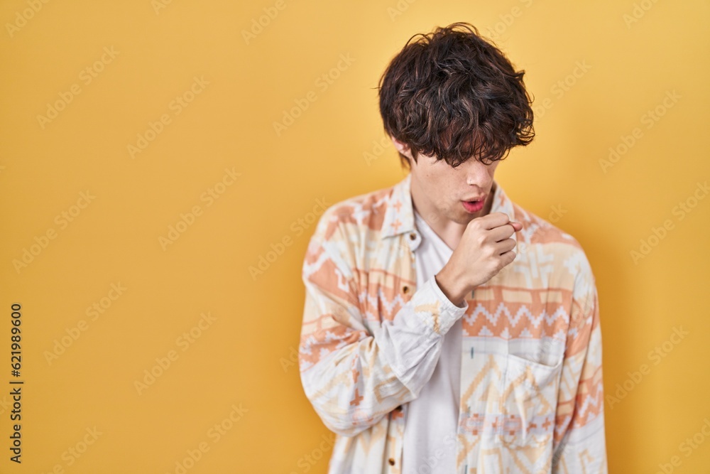 Young man wearing casual summer shirt feeling unwell and coughing as symptom for cold or bronchitis. health care concept. Young man wearing casual summer shirt feeling unwell and coughing as symptom for cold or bronchitis. health care concept.