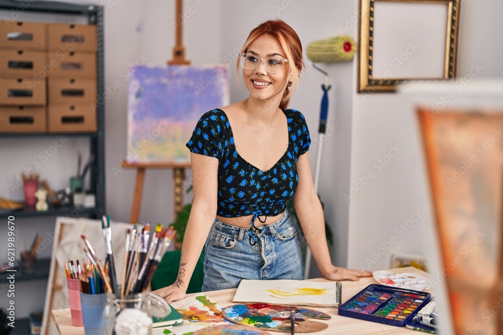 Fototapeta premium Young caucasian woman artist smiling confident standing at art studio
