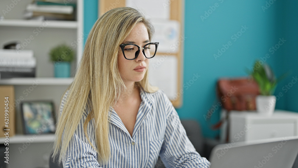 Young blonde woman business worker using laptop working at the office Young blonde woman business worker using laptop working at the office