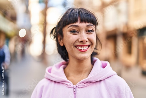 Young woman smiling confident standing at street