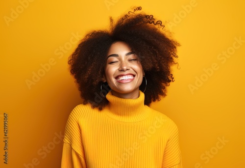 Beautiful smiling woman with curly hair on orange background © Unique Designs