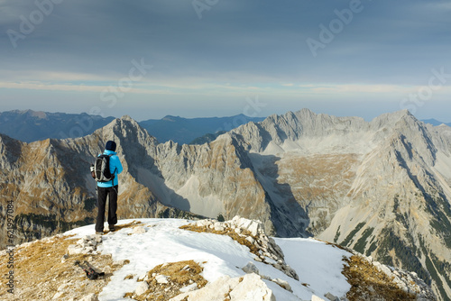 Eine Frau bestaunt die bizarren  Felsformationen vom Gipfel der Pleisenspitze photo