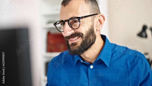 Young hispanic man business worker using computer working at office