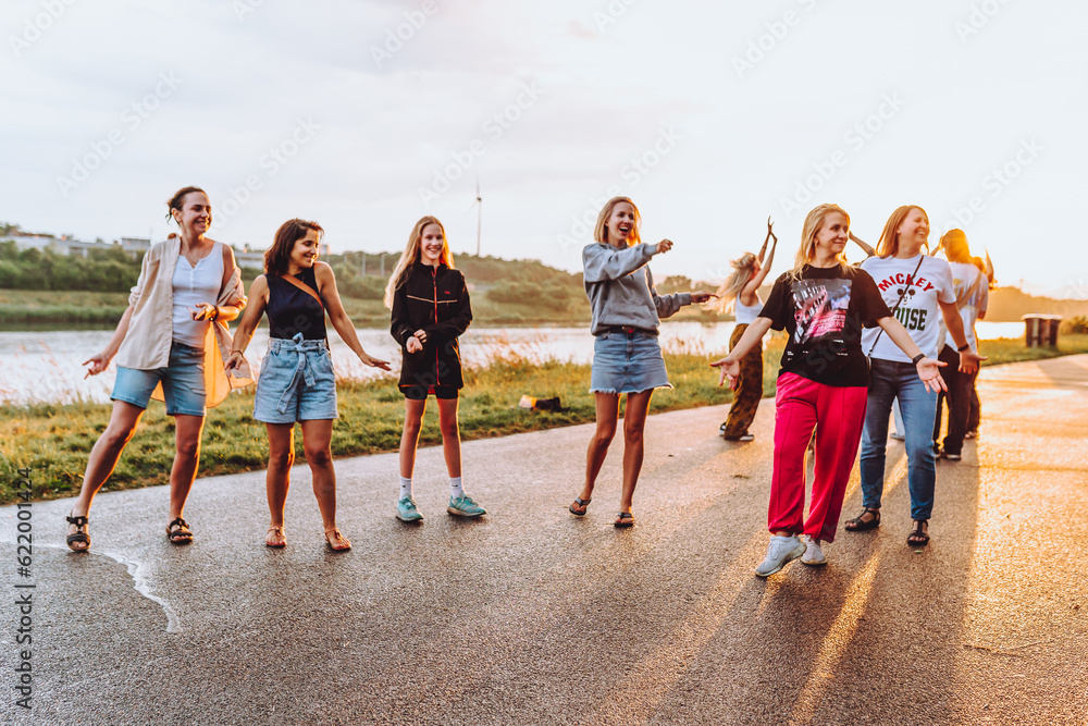 Fototapeta premium dancing cheerful attractive women at sunset. 