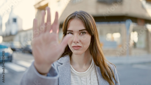 Wallpaper Mural Young hispanic woman doing stop gesture with hand at street Torontodigital.ca