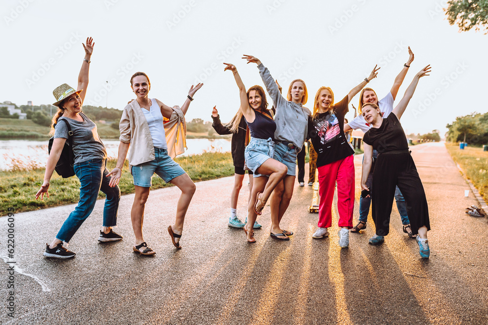 Obraz premium dancing cheerful attractive women at sunset. 