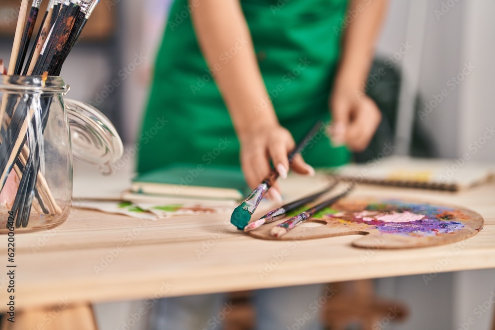 Obraz premium Young blonde woman artist holding paintbrush at art studio