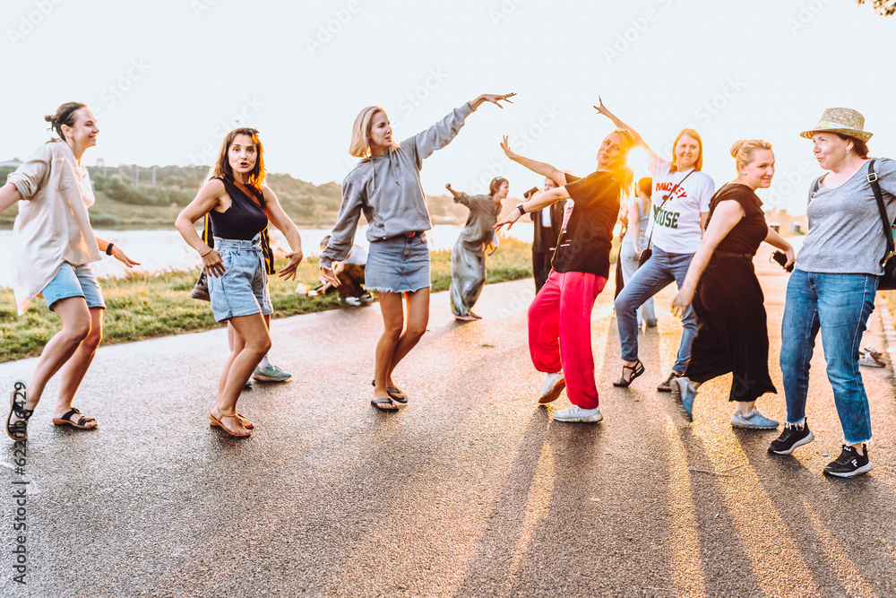Obraz premium dancing cheerful attractive women at sunset. 