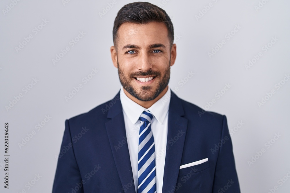 Handsome hispanic man wearing suit and tie with a happy and cool smile on face. lucky person. - obrazy, fototapety, plakaty 