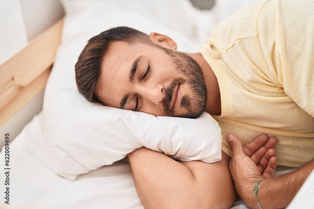 Young hispanic man lying on bed sleeping at bedroom Young hispanic man lying on bed sleeping at bedroom