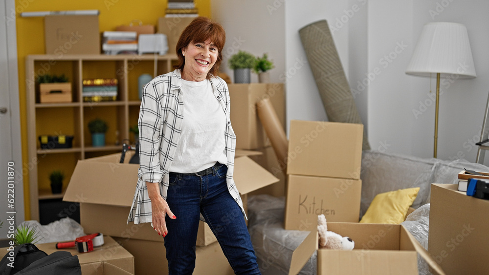 Middle age woman smiling confident standing at new home Middle age woman smiling confident standing at new home