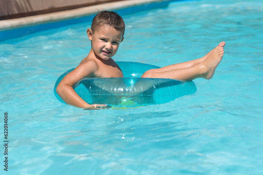 Child swimming in a pool with a float