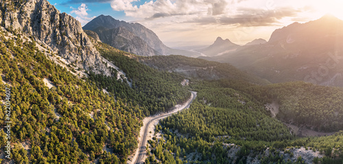 Aerial view of a scenic asphalt road in mountains in Turkey at majestic sunset with golden light