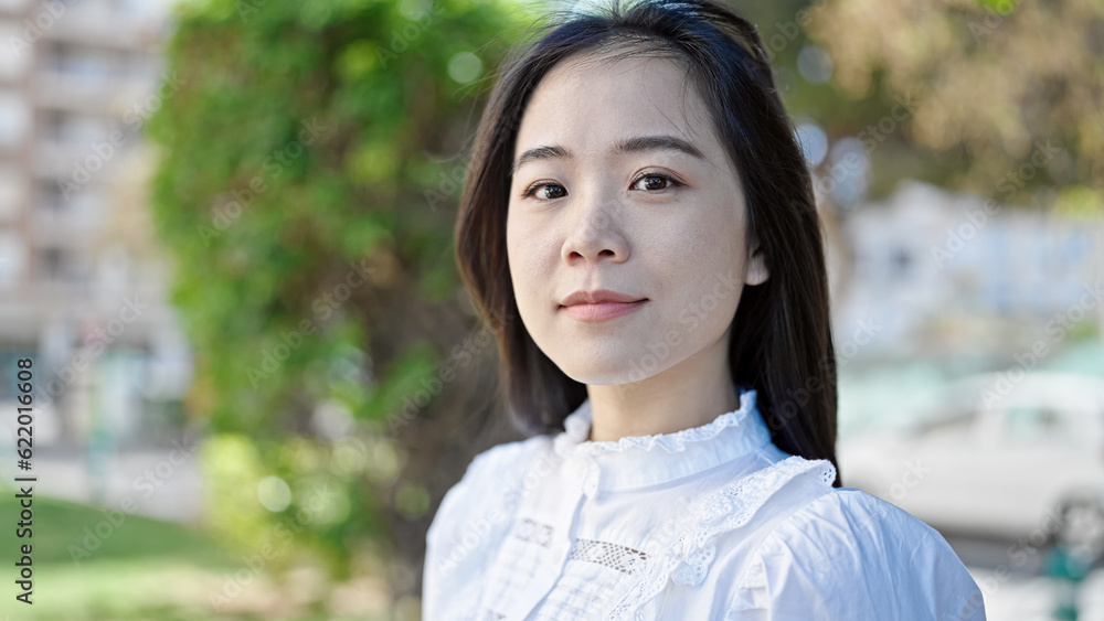 Young chinese woman smiling confident looking to the side at park Young chinese woman smiling confident looking to the side at park