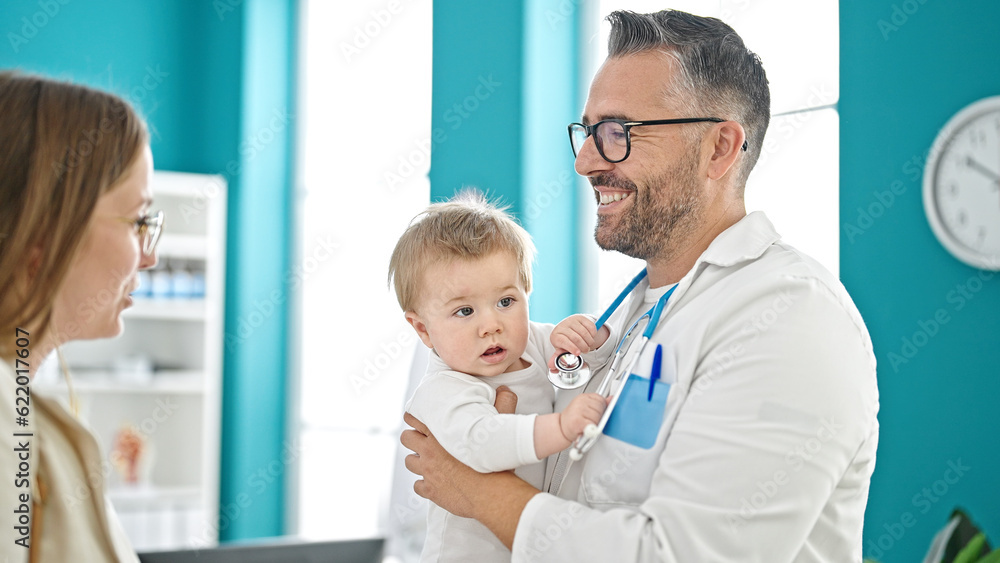 Fototapeta premium Caucasian mother with baby on a doctor appointment at clinic