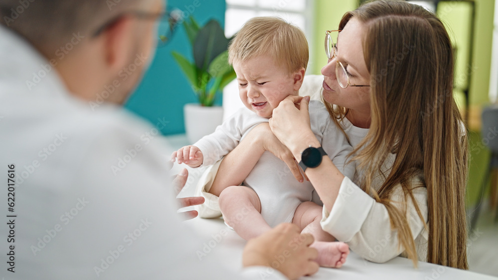 Caucasian mother with baby on a doctor appointment at clinic Caucasian mother with baby on a doctor appointment at clinic