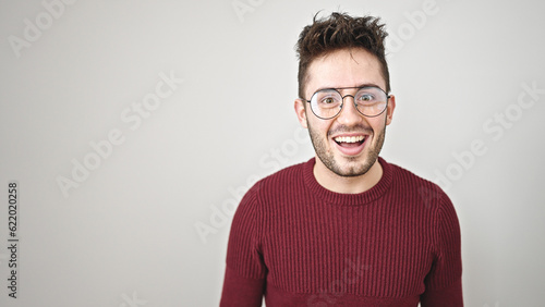 Young hispanic man smiling confident standing over isolated white background © Krakenimages.com