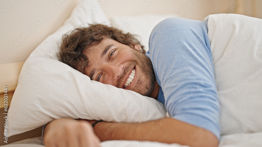 Young hispanic man smiling confident lying on bed at bedroom Young hispanic man smiling confident lying on bed at bedroom