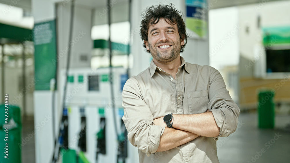 Young hispanic man smiling confident standing with arms crossed gesture at petrol station Young hispanic man smiling confident standing with arms crossed gesture at petrol station