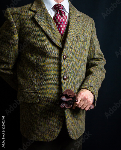 Portrait of Gentleman in Tweed Suit Holding Leather Gloves. Vintage Style of English Gentleman.