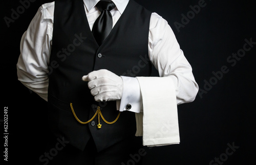 Portrait of Elegant Butler or Waiter in Black Vest and White Gloves Eager to be of Service.