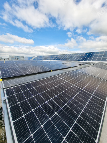 Eco building or factory  of solar or photovoltaic cell  on top of roof. Technology to generate electrical power, direct current electricity by light. Energy for future.