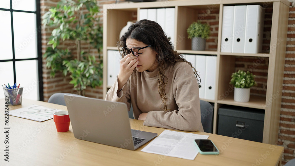 Young beautiful hispanic woman business worker stressed using laptop at office Young beautiful hispanic woman business worker stressed using laptop at office