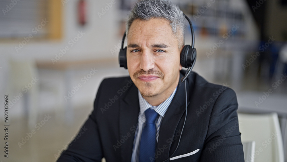 Young hispanic man business worker using laptop and headphones at office Young hispanic man business worker using laptop and headphones at office