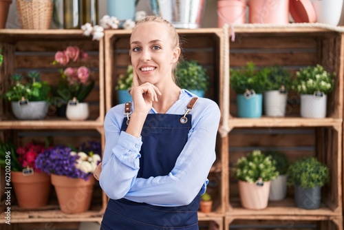 Young blonde woman florist smiling confident standing with arms crossed gesture at florist