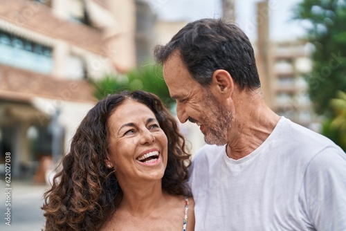 Man and woman couple smiling confident standing together at street