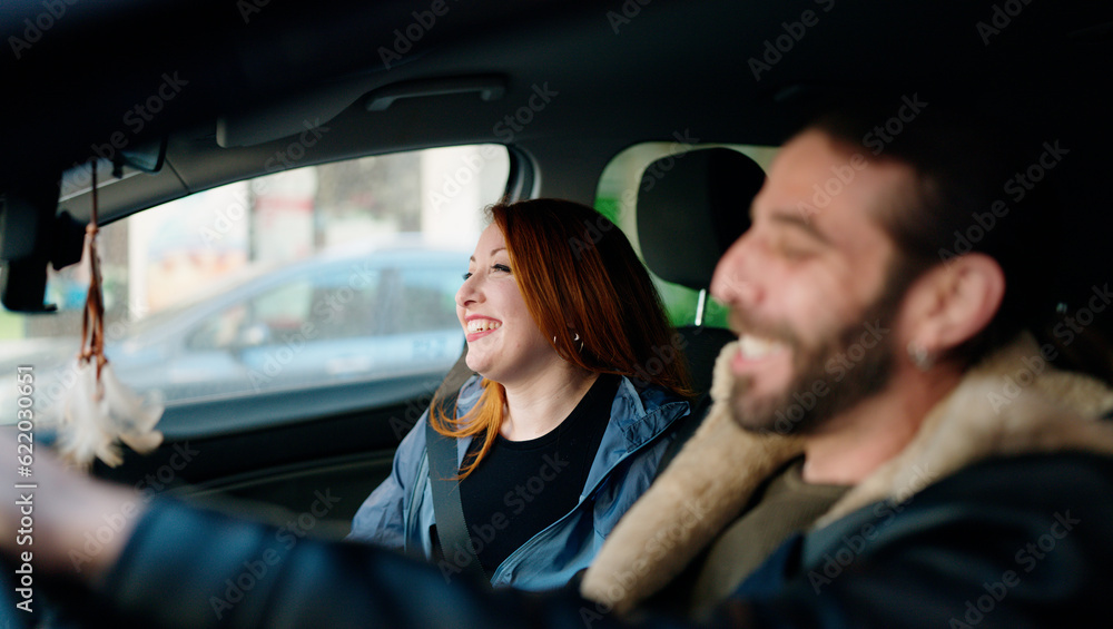 Man and woman couple smiling confident driving car at street Man and woman couple smiling confident driving car at street