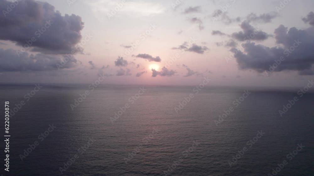 Beautiful sunset with a view of the sea and clouds. Top view from a drone on a sandy beach and water. Tourists relax and swim. The green hills of Phuket Island, Thailand. Houses and tall palm trees Beautiful sunset with a view of the sea and clouds. Top view from a drone on a sandy beach and water. Tourists relax and swim. The green hills of Phuket Island, Thailand. Houses and tall palm trees