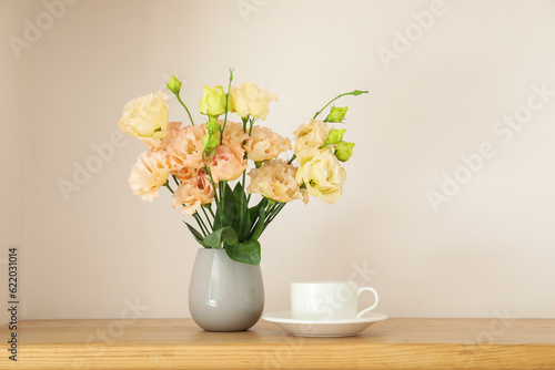 Coffee and a vase with flowers on the table