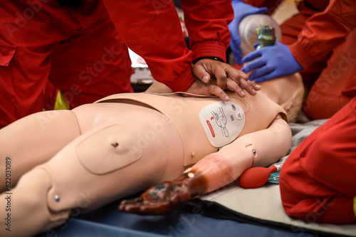 Paramedics simulate emergency intervention on medical training manikin © roibu