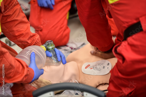 Paramedics simulate emergency intervention on medical training manikin