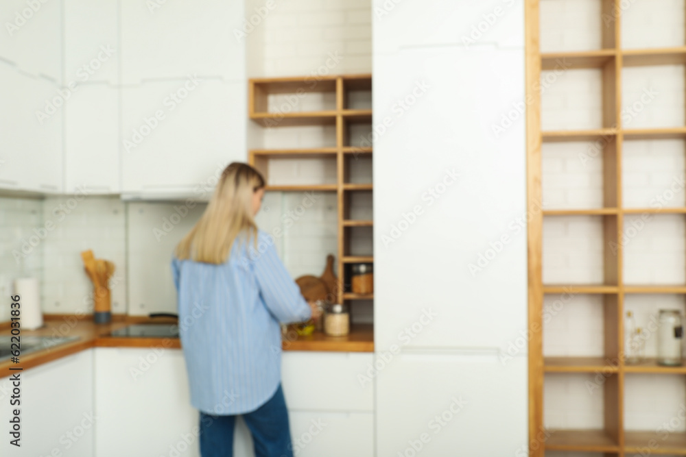 A young woman is preparing breakfast in the kitchen A young woman is preparing breakfast in the kitchen