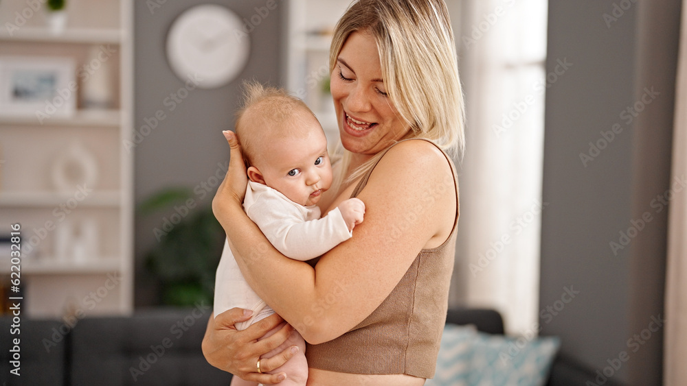 Mother and daughter hugging each other standing at home Mother and daughter hugging each other standing at home