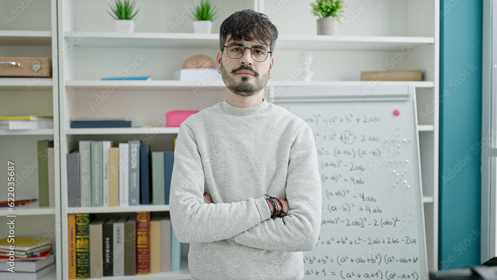 Young hispanic man standing by white board at university classroom Young hispanic man standing by white board at university classroom