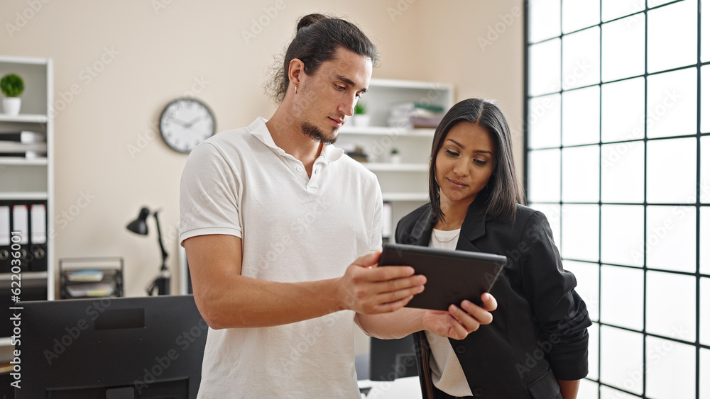 Fototapeta premium Man and woman business workers using touchpad working at office