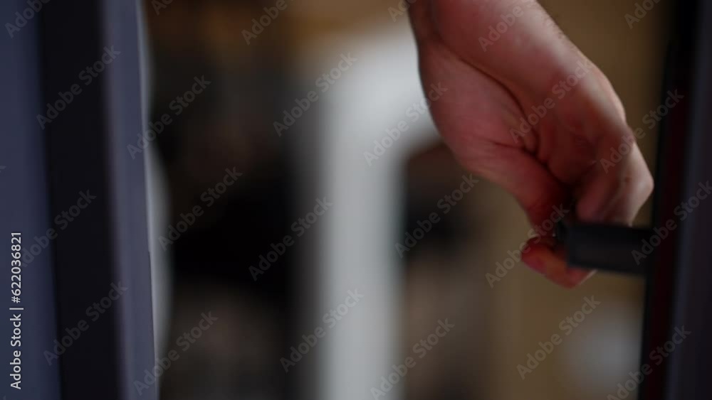 Closeup male hand opening door handle and unrecognizable man entering closing door. Young Caucasian guy walking inside house Closeup male hand opening door handle and unrecognizable man entering closing door. Young Caucasian guy walking inside house