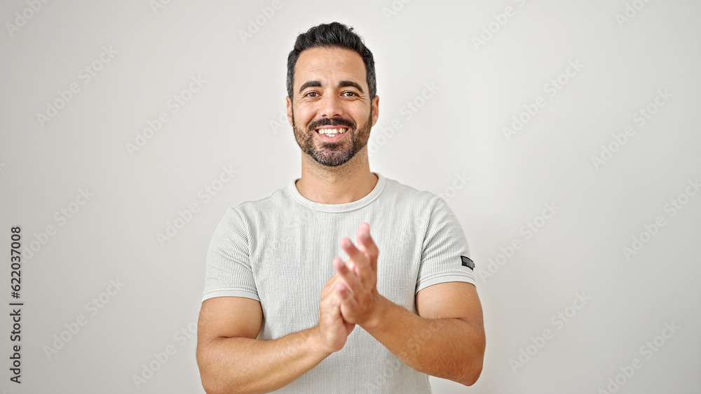 Young hispanic man smiling confident clapping hands over isolated white background Young hispanic man smiling confident clapping hands over isolated white background