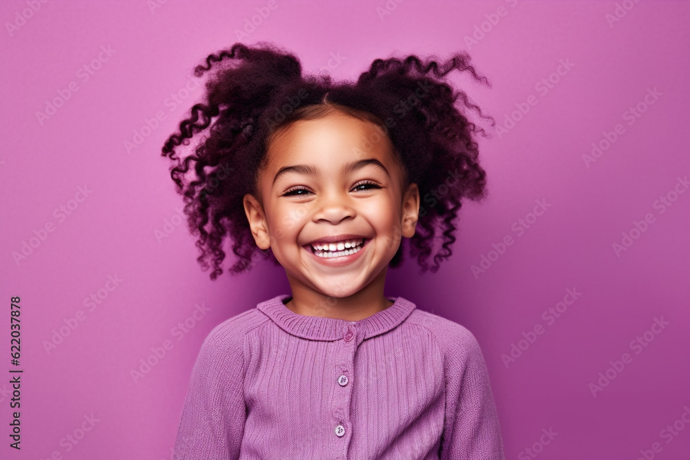 Cute little girl portrait on studio background, smiling child in purple
