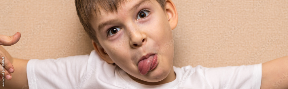 child indulges in front of the camera. portrait of a boy of six years old close-up. child indulges in front of the camera. portrait of a boy of six years old close-up.