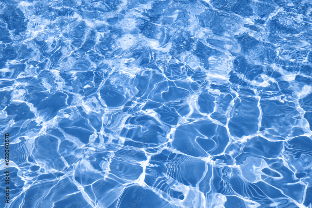 Fototapeta premium Abstract water background with ripples. Light caustics effect. Play of light and shadow, texture of twaves and splashes.