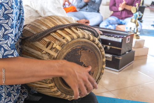 close-up of hands playing a drum for meditation to chant mantras